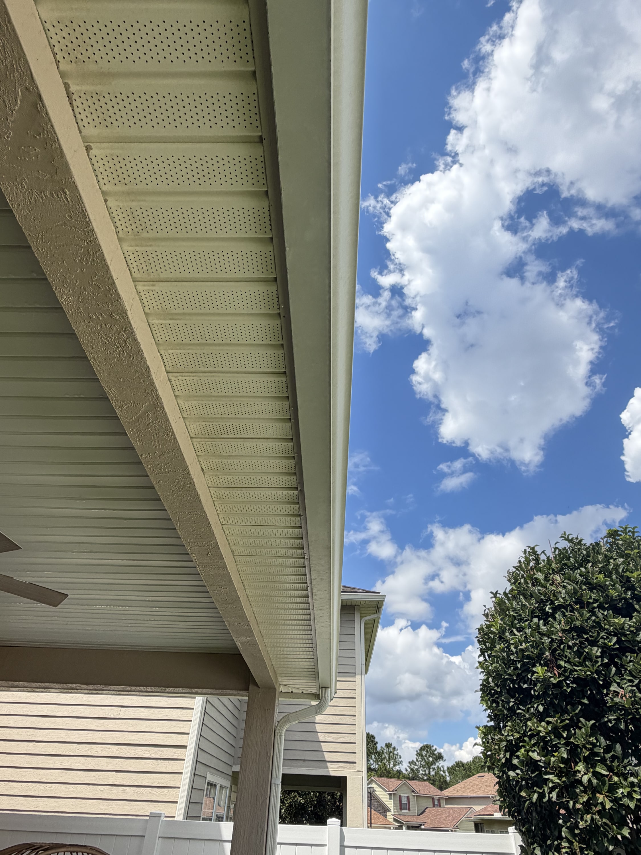 New soffit and fascia installation on house exterior, cream-coloured with perforated ventilation detail.
