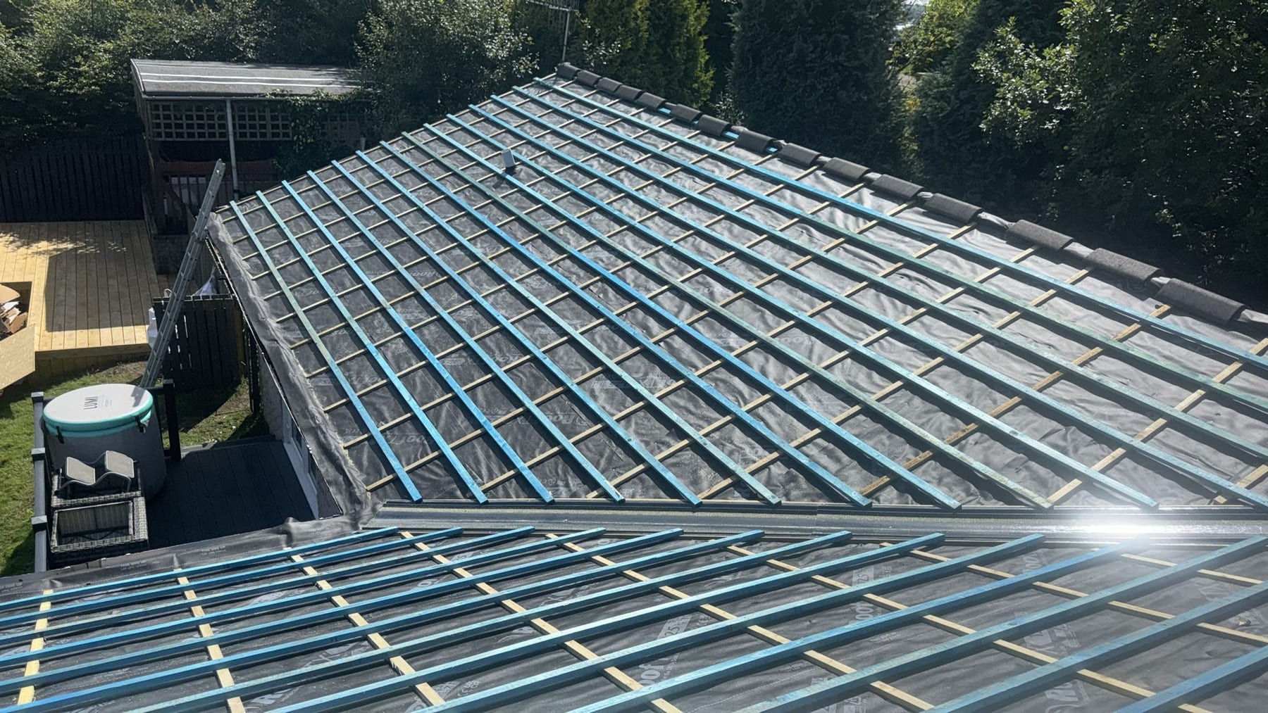 Steel roof frame and rafter system installed on a house, showing galvanised steelwork and membrane.