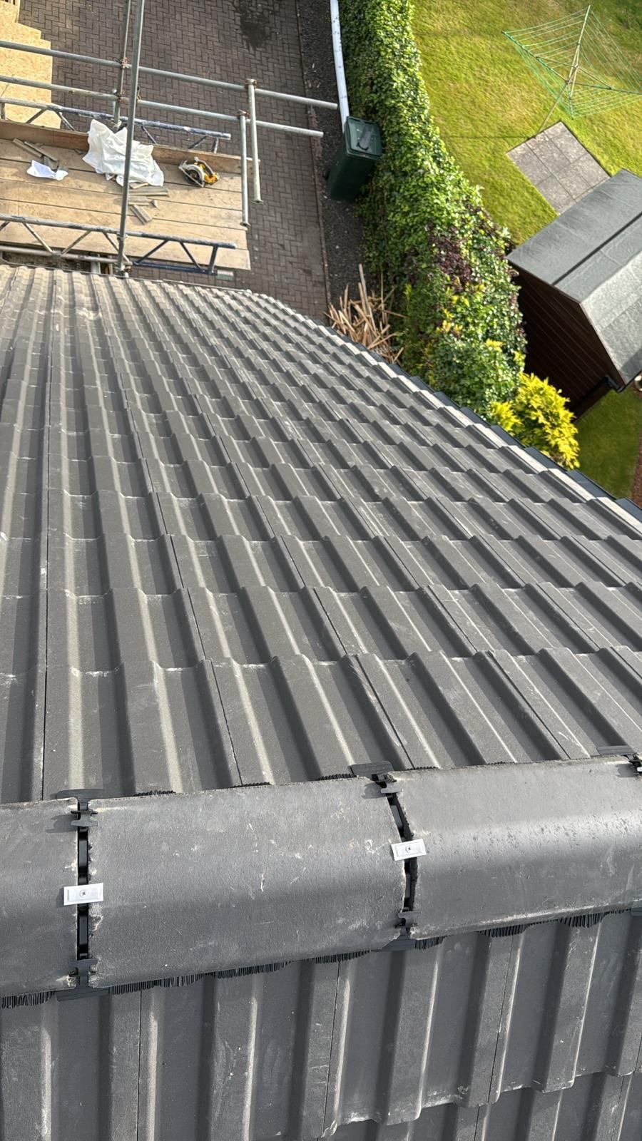 Marley Major concrete roof tiles being laid, seen from the scaffold